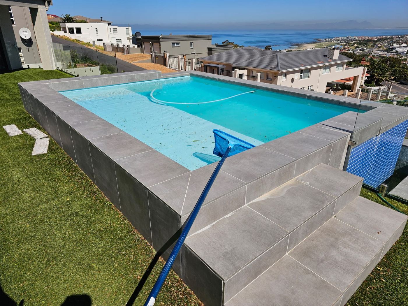 Raised infinity pool with a view over Strand beach and False Bay