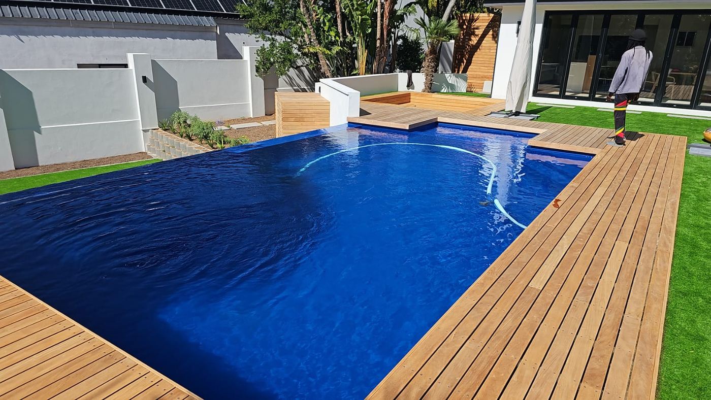 Navy blue pool surrounded by a new timber deck